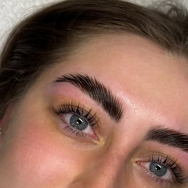A lifted lash and laminated brow result, blue eyes