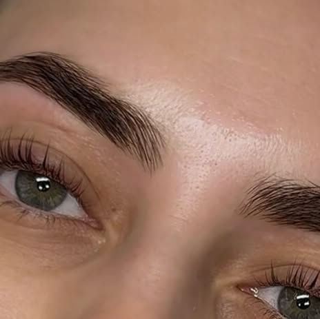 A shaped, defined brow with lashes, green eyes