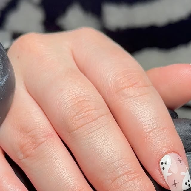 Nude nails with a Halloween ghost accent nail
