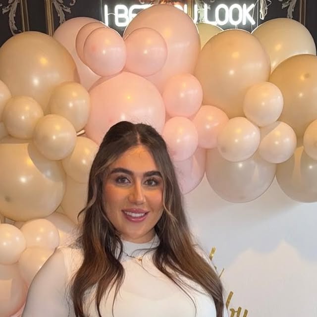 The Cuticle Club studio balloon wall under a Beauty Look neon sign